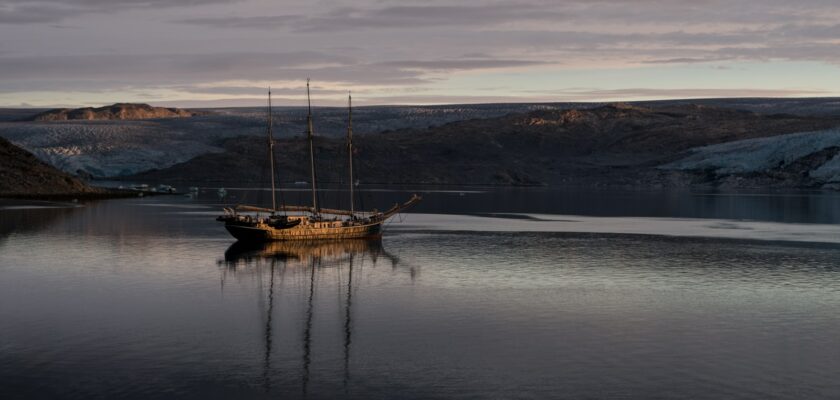 gray sailboat near island